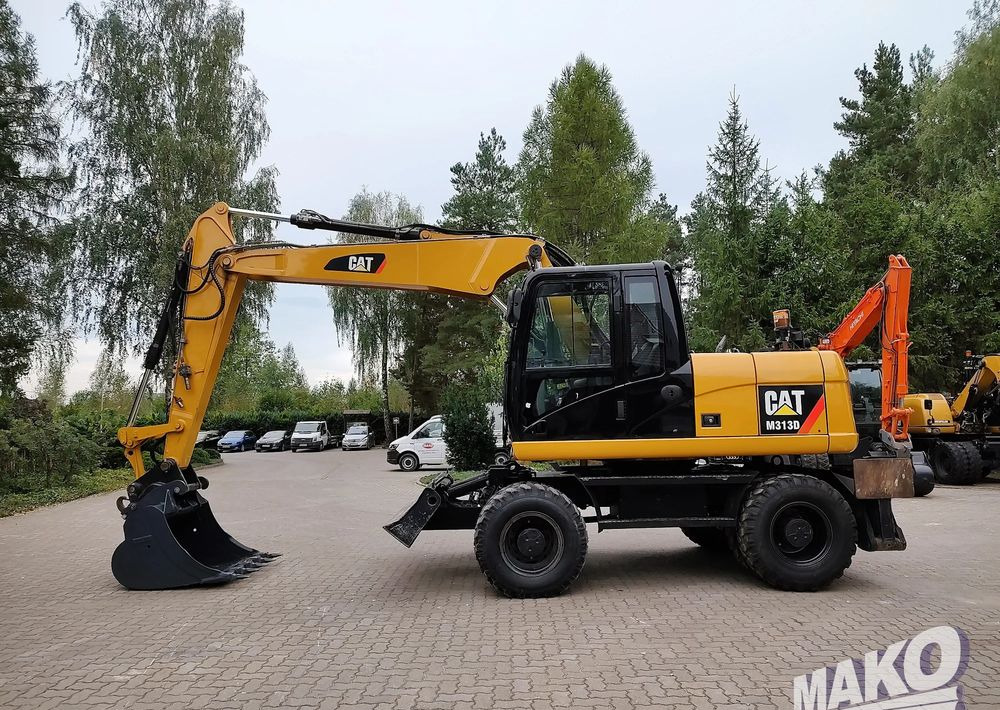Caterpillar M313D - Escavadeira de rodas: foto 1 Caterpillar M313D - Escavadeira de rodas: foto 1
