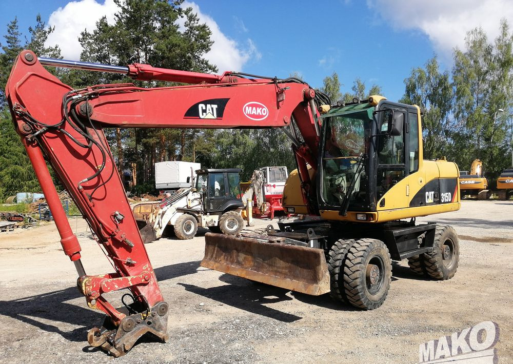 Caterpillar M315 C - Escavadeira de rodas: foto 1 Caterpillar M315 C - Escavadeira de rodas: foto 1