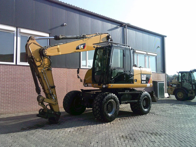 Caterpillar M315D - Escavadeira de rodas: foto 1 Caterpillar M315D - Escavadeira de rodas: foto 1