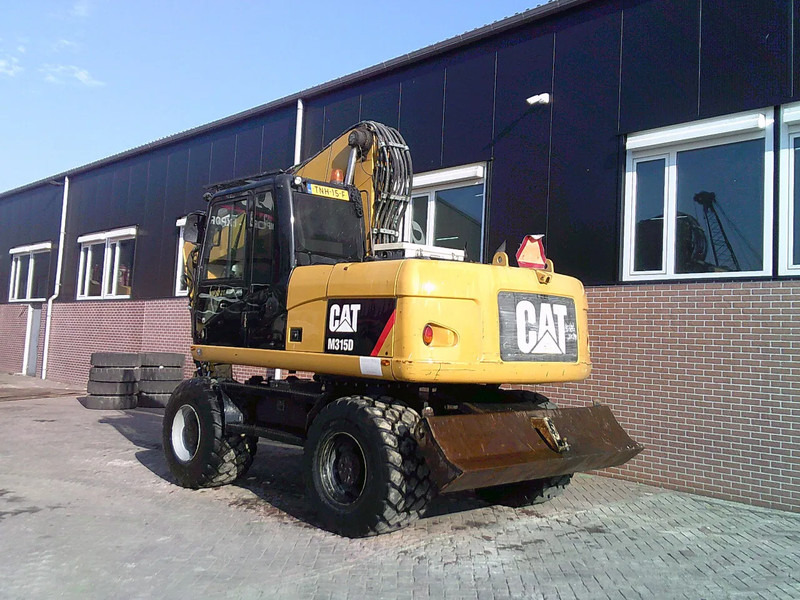 Caterpillar M315D - Escavadeira de rodas: foto 2 Caterpillar M315D - Escavadeira de rodas: foto 2