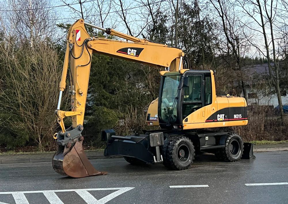 Caterpillar CAT M315C CATERPILLAR SPROWADZONY Bardzo Dobry Stan - Escavadeira de rodas: foto 1 Caterpillar CAT M315C CATERPILLAR SPROWADZONY Bardzo Dobry Stan - Escavadeira de rodas: foto 1