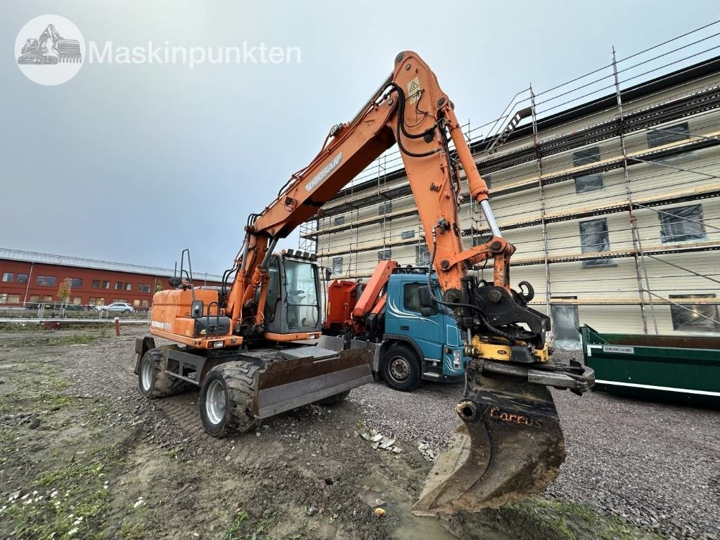 Doosan DX 140 W med vagn och redskap - Escavadeira de rodas: foto 2 Doosan DX 140 W med vagn och redskap - Escavadeira de rodas: foto 2