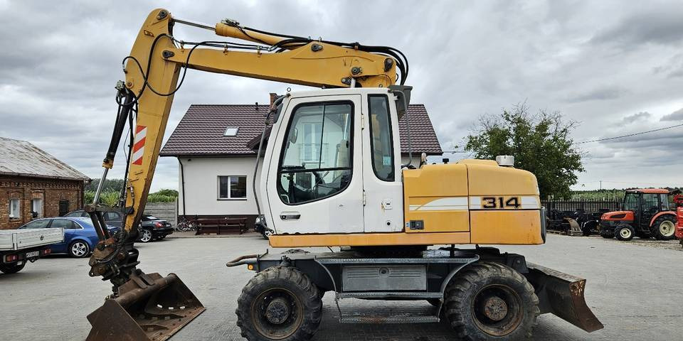 Koparka kołowa Liebherr A314 Litronic 9350 h+ 5 łyżek kołówka - Escavadeira de rodas: foto 1 Koparka kołowa Liebherr A314 Litronic 9350 h+ 5 łyżek kołówka - Escavadeira de rodas: foto 1