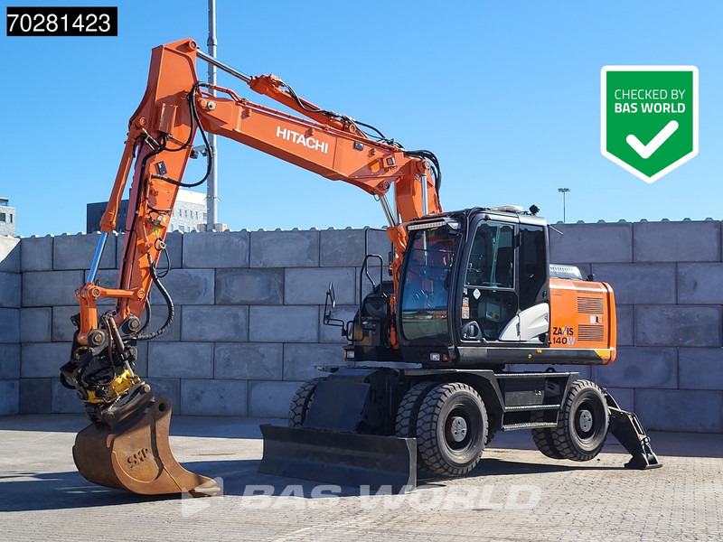 Hitachi ZX140W -5 OUTRIGGERS + BLADE - Escavadeira de rodas: foto 1 Hitachi ZX140W -5 OUTRIGGERS + BLADE - Escavadeira de rodas: foto 1